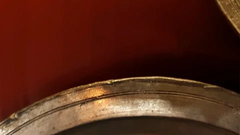 Combined overhead video showing different angles of antique, aged metal plates Vídeos de archivo 334108592
