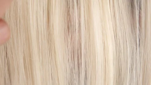 Combing blond hair with a comb close-up Stock Footage 320602793