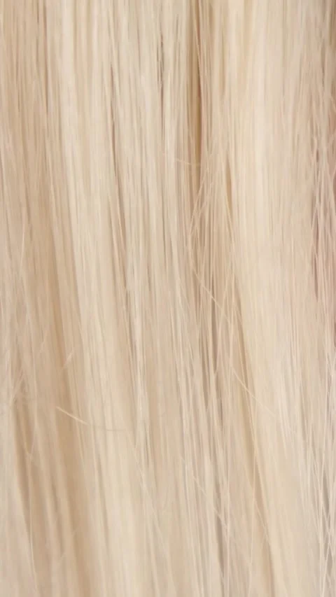 Combing blond hair with a comb close-up Stock Footage 320837894