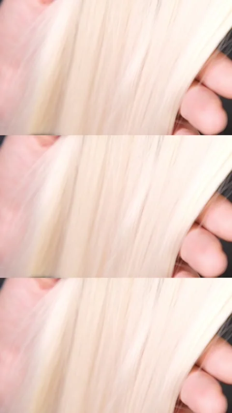 Combing blond hair with a comb close-up Stock Footage 321292068