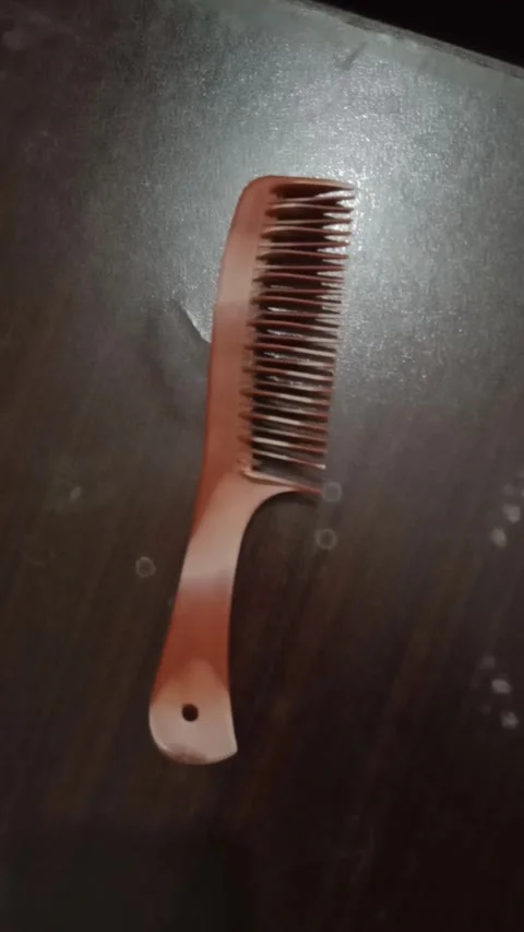 Combing hair with traditional comb Stock Footage 321924896