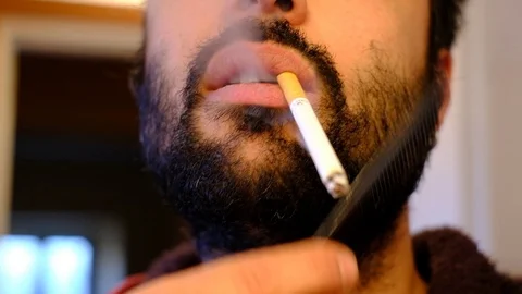 Combing his beard at home Video stock 100635762