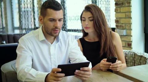 Combining their expertise. Young handsome man discussing something with his Stock Footage 68864262