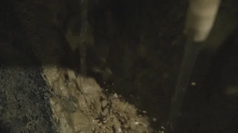 Combining water and a crushed mixture Stock Footage 304355545