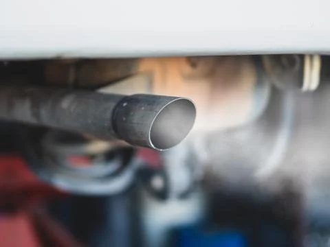 Combustion fumes coming out of car exhaust pipe Stock Photos
