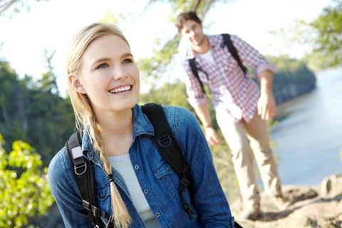 Come over here and look at this view. An attractive young hiker waiting for her Stock Photos