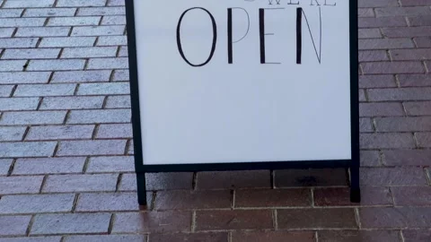 Come In We're Open Hand Drawn Sidewalk Sign on Bricks - Pan up Stock-Footage 201747057