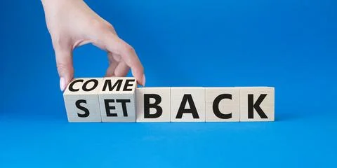 Comeback and setback symbol. Hand turns a cube and changes the word setback.. Stock Photos