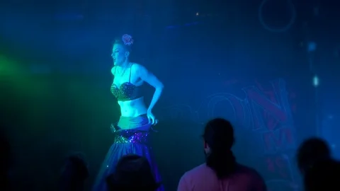 Comedy, burlesque dancer has trouble getting her dress off on stage while Stock Footage 93680567