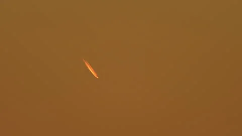 Comet crosses orange red sky during sun set. Shooting star meteor with dust.. Stock Footage 293845287