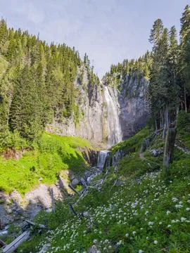 Comet Falls cascading down rocky cliff in lush forest Stock Photos