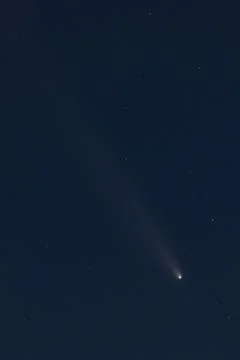 Comet with glowing tail moving through dark space Stock Photos