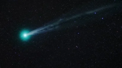 A comet with a long luminous tail streaks across the night sky. Stock Footage 311381145