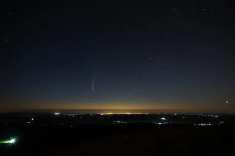 Comet in the night sky in the mountains Stock Photos