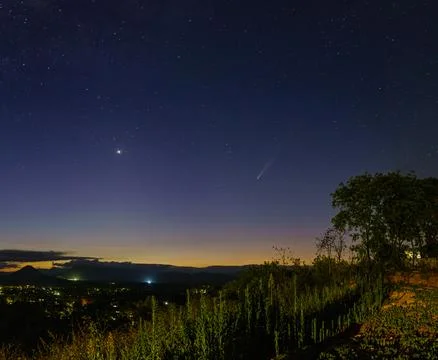 Comet over the blue hour sunset from the top of a hill Stock Photos