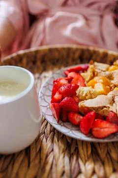 Comfortable bed, breakfast in bed. female hands hold a wooden tray with apple Stock Photos