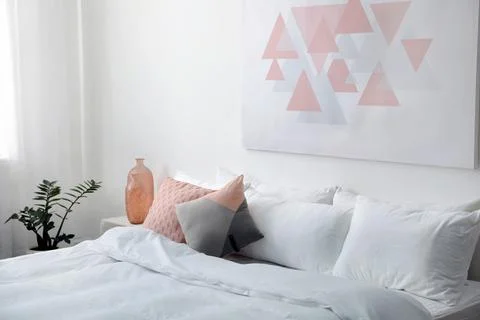 Comfortable bed with soft pillows in room interior 스톡 사진