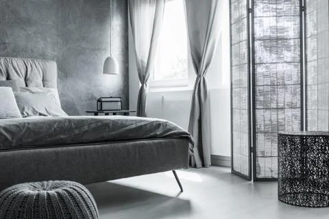 Comfortable bedroom with gray wall Stock-Fotos