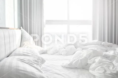 Comfortable bedroom,messy bedding sheets and duvet with wrinkle messy in the Stock Photos
