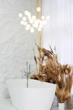 Comfortable bright bathroom with a boho-chic interior design, a free-standi.. Stock Photos