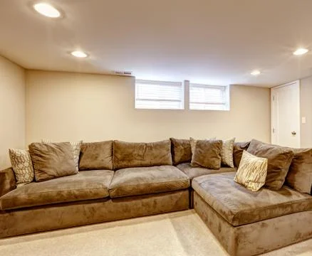 Comfortable brown sofa with pillows Stock Photos