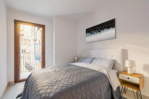 Comfortable double bed in bedroom with a panoramic door-window and a stylish 스톡 사진