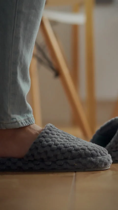 Comfortable hand-knit slippers for cozy indoor lounging and relaxation Stock Footage 331534417