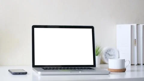 Comfortable home office. Laptop computer, stationery and potted plant on wh.. Stock-Fotos