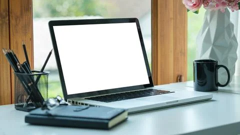 Comfortable home office. Laptop computer, stationery and potted plant on wh.. Foto stock