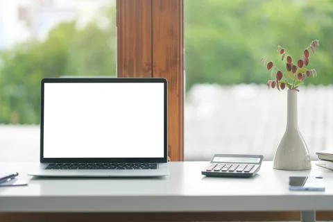 Comfortable home office. Laptop computer, stationery and potted plant on wh.. Stock-Fotos