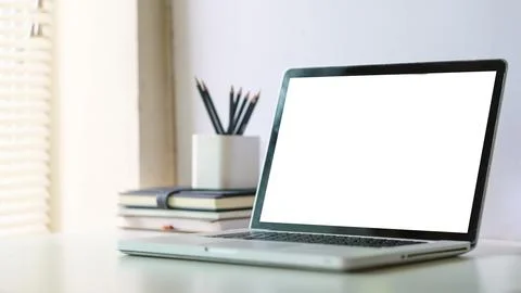 Comfortable home office. Laptop computer, stationery and potted plant on wh.. Stock Photos