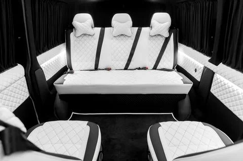 Comfortable interior of a passenger bus with soft seats Stock Photos