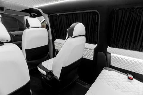 Comfortable interior of a passenger bus with soft seats Stock Photos
