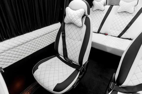 Comfortable interior of a passenger bus with soft seats Stock Photos