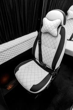 Comfortable interior of a passenger bus with soft seats Stock Photos