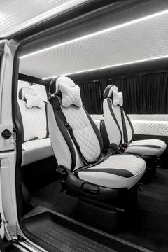 Comfortable interior of a passenger bus with soft seats Stock Photos