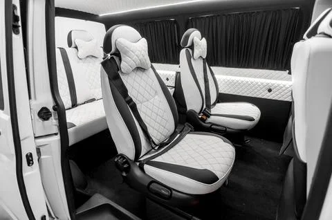 Comfortable interior of a passenger bus with soft seats Stock Photos