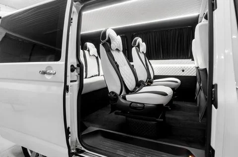 Comfortable interior of a passenger bus with soft seats Stock Photos