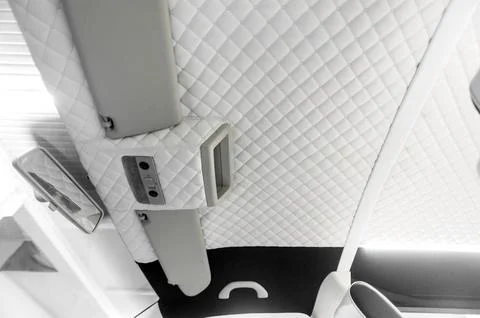 Comfortable interior of a passenger bus with soft seats Stock Photos