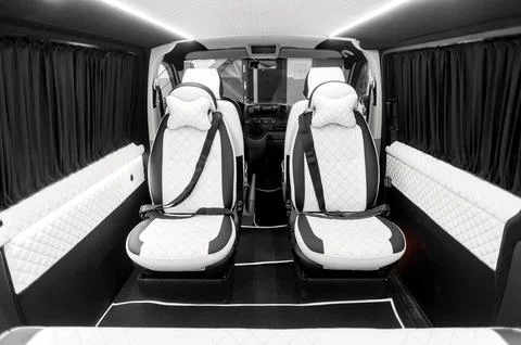 Comfortable interior of a passenger bus with soft seats Stock Photos