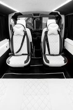 Comfortable interior of a passenger bus with soft seats Stock-Fotos