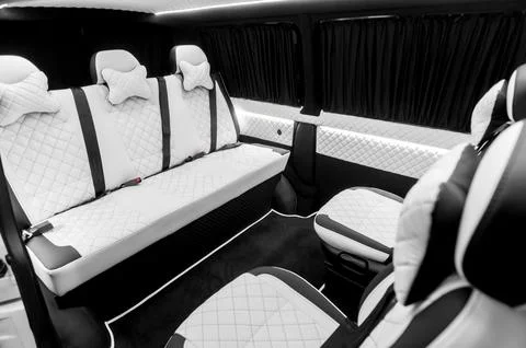 Comfortable interior of a passenger bus with soft seats Stock Photos