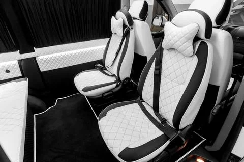 Comfortable interior of a passenger bus with soft seats Stock Photos