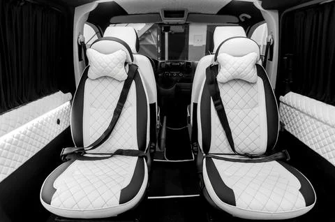 Comfortable interior of a passenger bus with soft seats Stock Photos