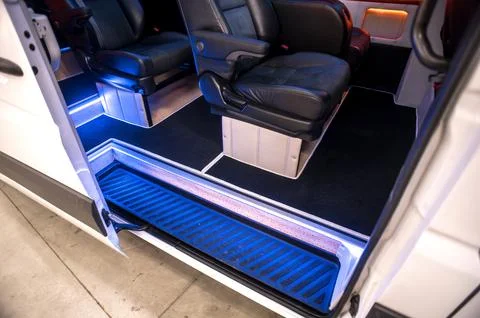 Comfortable interior of a passenger bus with soft seats Stock Photos