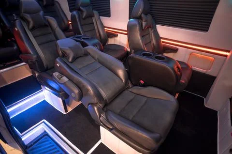 Comfortable interior of a passenger bus with soft seats Stock Photos