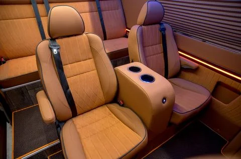 Comfortable interior of a passenger bus with soft seats Stock Photos