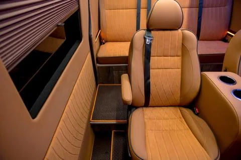 Comfortable interior of a passenger bus with soft seats Stock Photos