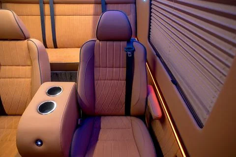 Comfortable interior of a passenger bus with soft seats Stock Photos
