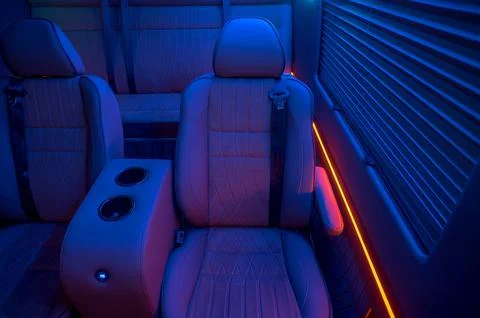 Comfortable interior of a passenger bus with soft seats Stock Photos